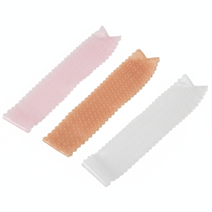 Silicone wig grip bands in pink, skin tone and transparent on white background